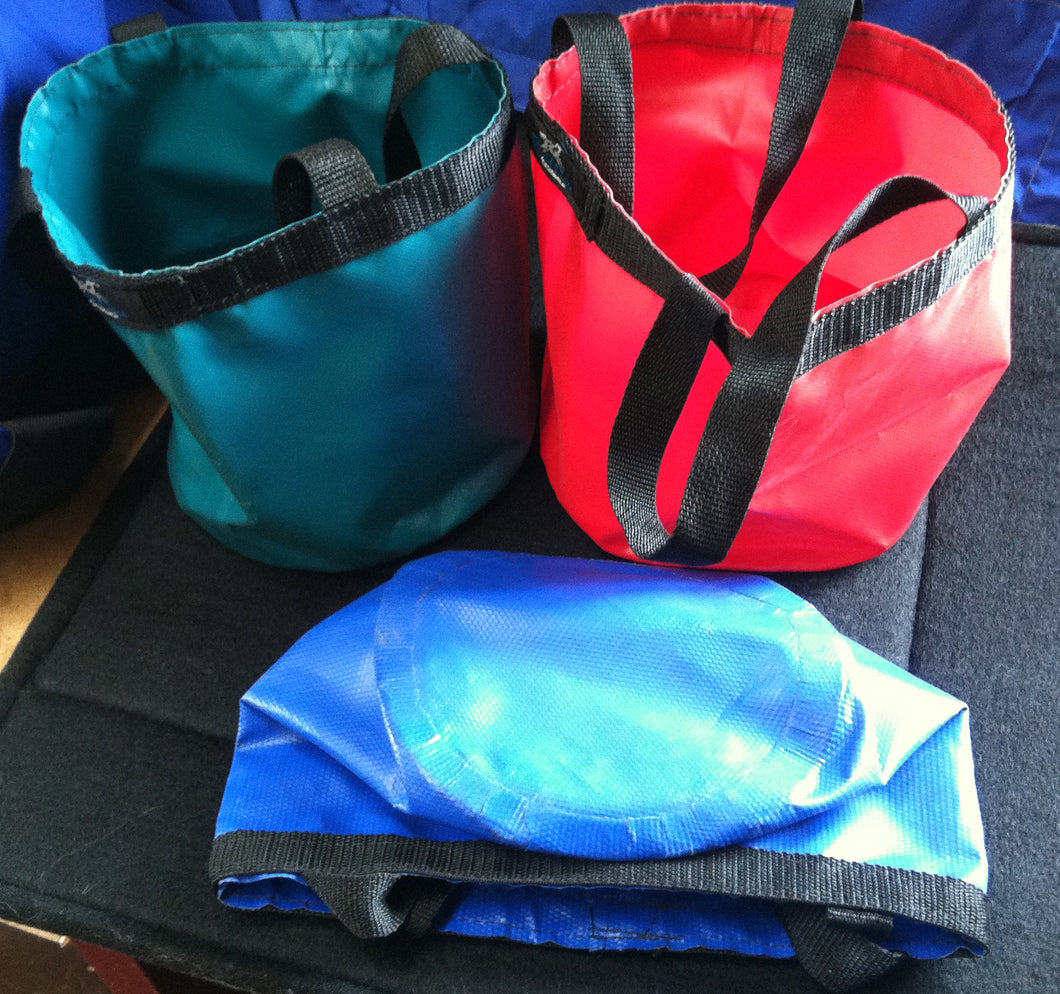 Blue, green, and red foldable vinyl water buckets.